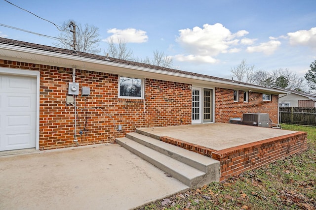 rear view of house featuring a patio and central AC unit