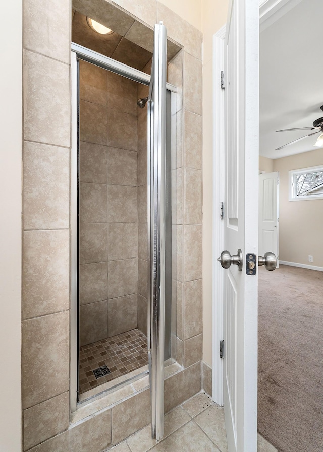 bathroom with tile patterned floors, ceiling fan, and walk in shower