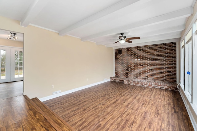 empty room featuring french doors, brick wall, ceiling fan, beam ceiling, and dark hardwood / wood-style floors