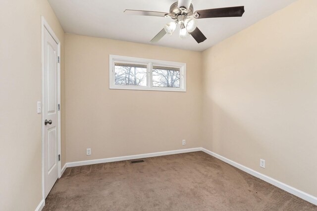 unfurnished room featuring ceiling fan and carpet