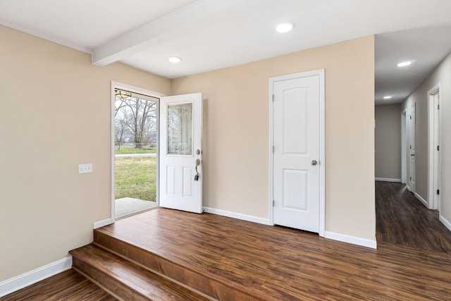 foyer with beam ceiling, dark hardwood / wood-style floors, and plenty of natural light