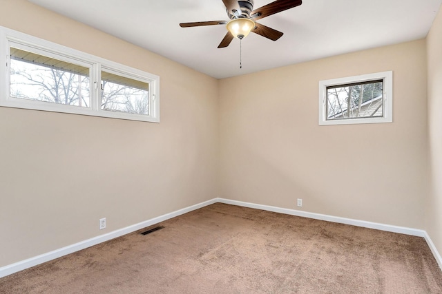 empty room featuring carpet floors and ceiling fan