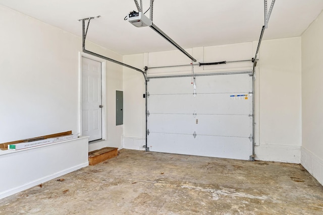 garage with electric panel and a garage door opener