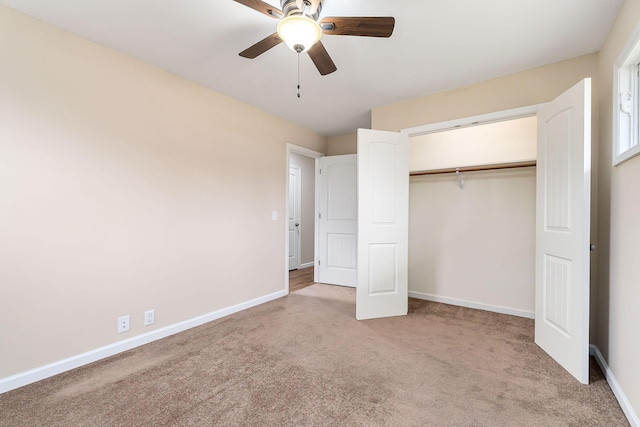 unfurnished bedroom with ceiling fan, a closet, and light carpet