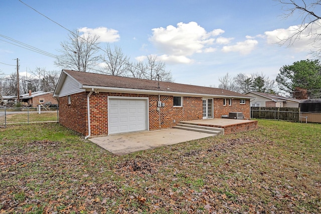 rear view of property featuring a lawn and a patio