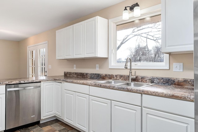 kitchen with white cabinets, dishwasher, and sink