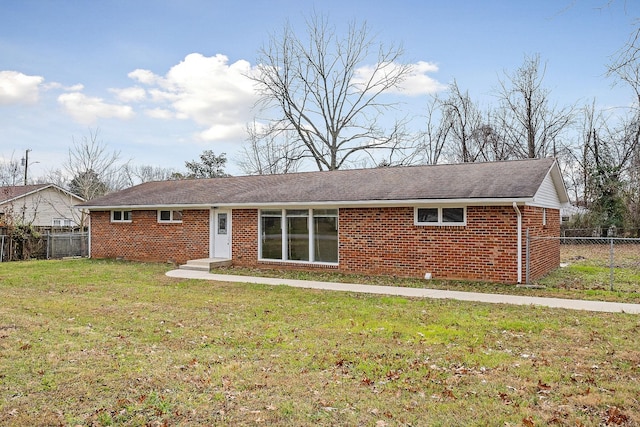 back of property featuring a lawn