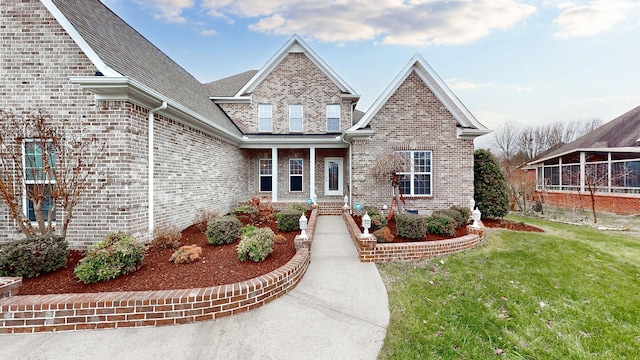 view of front of property with brick siding and a front yard