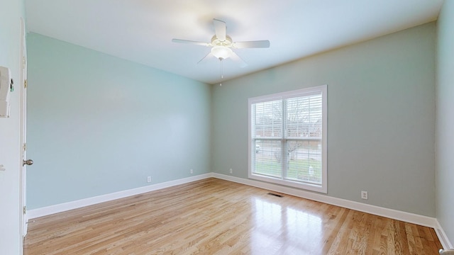 unfurnished room with light wood-type flooring, ceiling fan, and baseboards