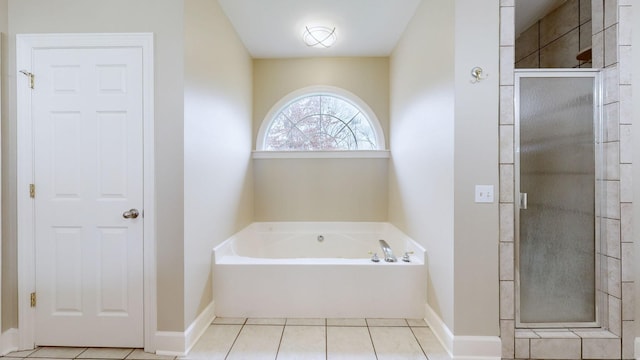 bathroom with a garden tub, baseboards, a stall shower, and tile patterned floors