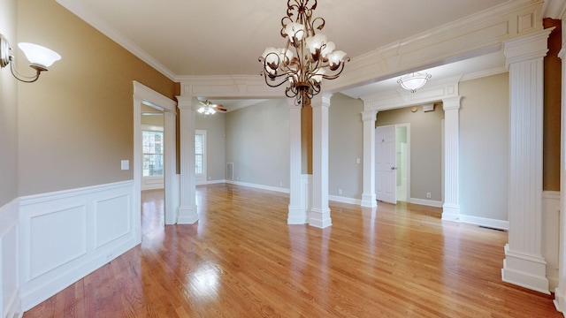 unfurnished room with light wood-type flooring, decorative columns, ceiling fan, and crown molding