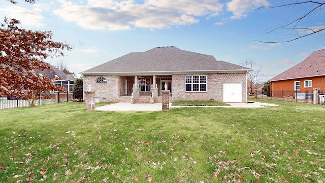 rear view of property with crawl space, a yard, a fenced backyard, and brick siding