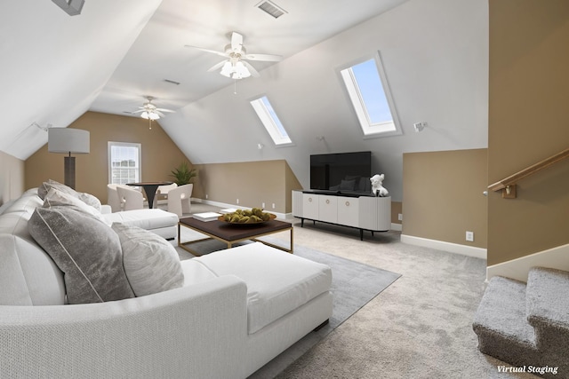 living area with light carpet, baseboards, visible vents, lofted ceiling with skylight, and ceiling fan