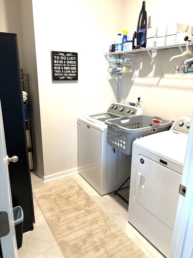 washroom featuring independent washer and dryer and light tile patterned floors