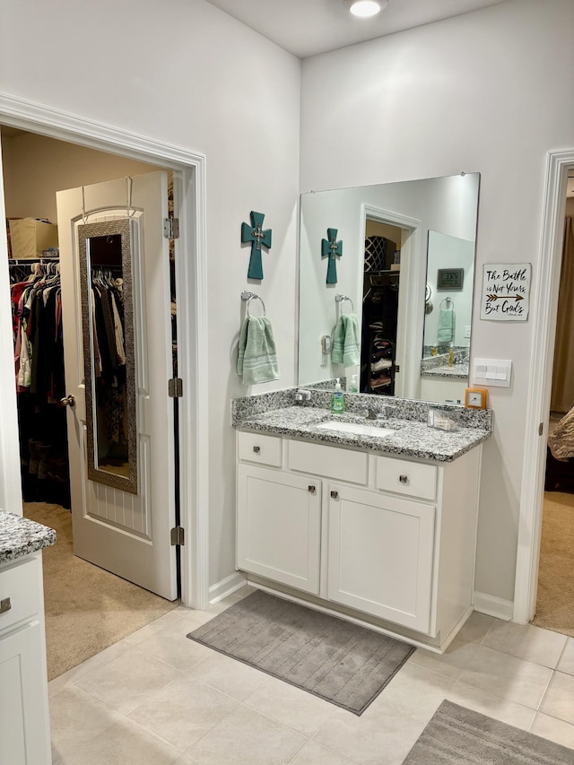 bathroom with tile patterned floors and vanity