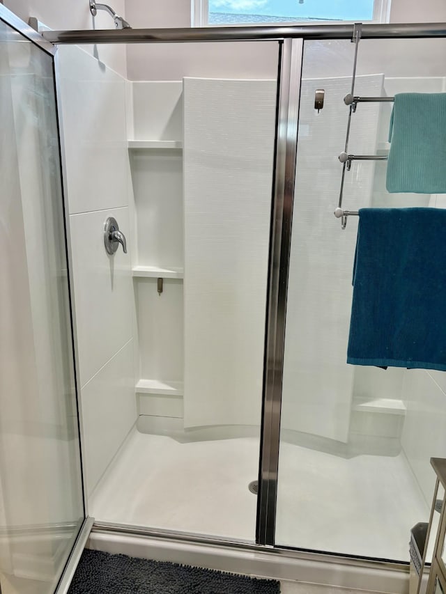 bathroom featuring a shower with shower door