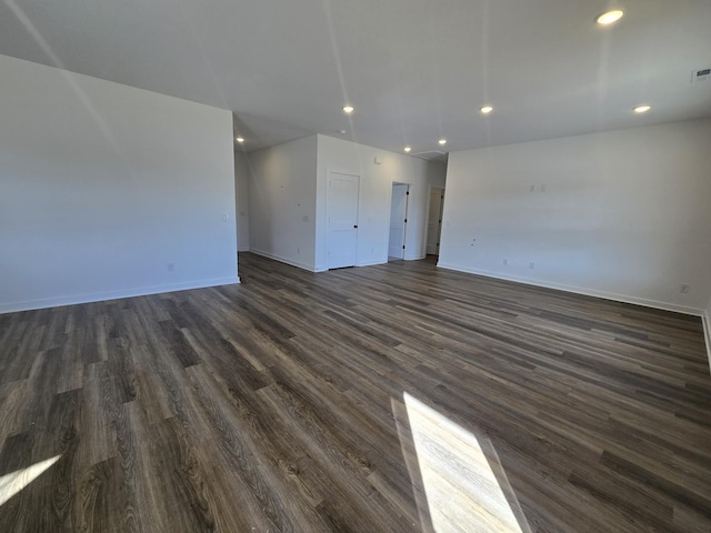 unfurnished living room featuring dark wood-type flooring