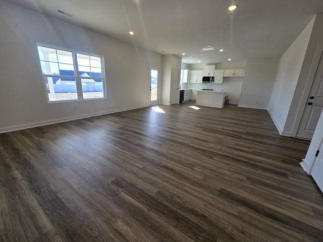 unfurnished living room featuring dark wood-type flooring