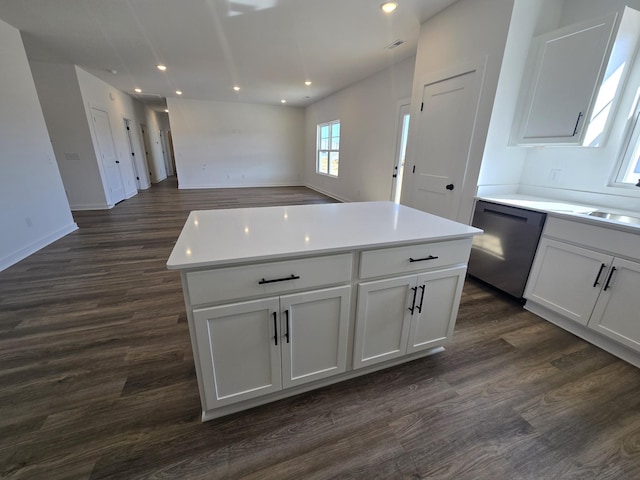 kitchen featuring white cabinetry, dark wood-type flooring, dishwasher, and a kitchen island