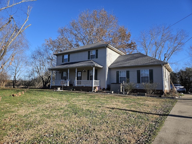 view of front facade featuring covered porch and a front lawn