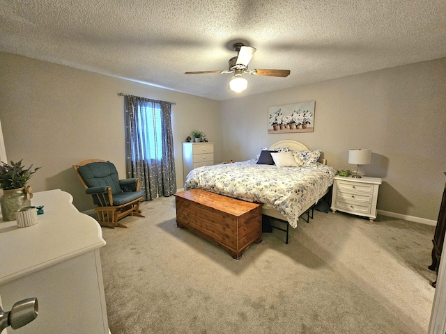 bedroom featuring carpet, a textured ceiling, and ceiling fan