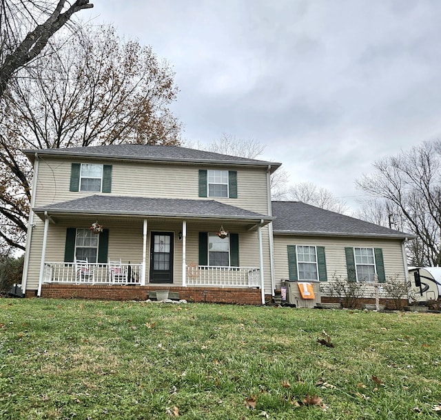 front facade with covered porch and a front lawn