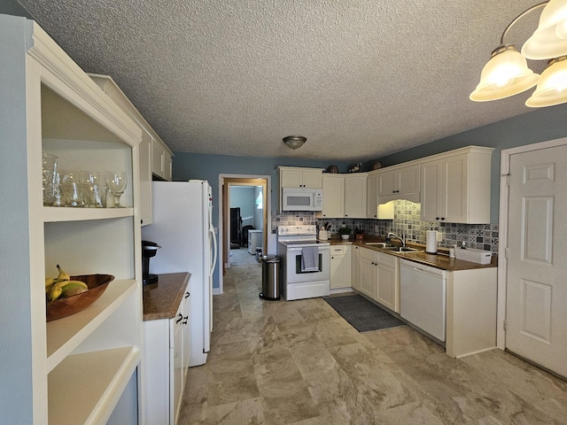 kitchen with white cabinets, white appliances, sink, and tasteful backsplash