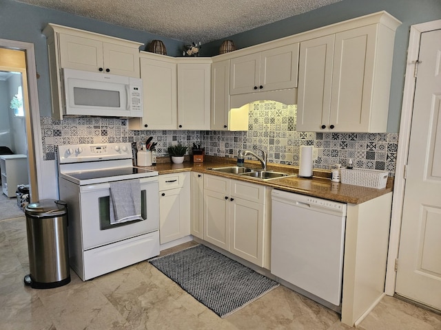 kitchen featuring a textured ceiling, decorative backsplash, white appliances, and sink