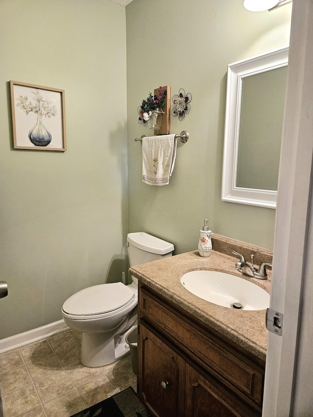 bathroom featuring tile patterned floors, vanity, and toilet