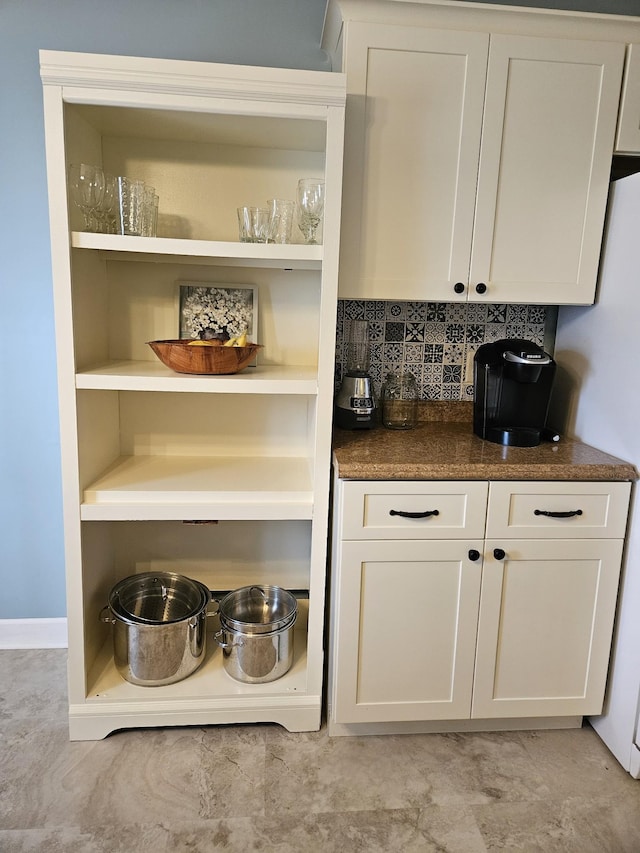 bar featuring white cabinets, white refrigerator, and tasteful backsplash