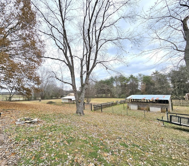 view of yard featuring a rural view and an outdoor structure