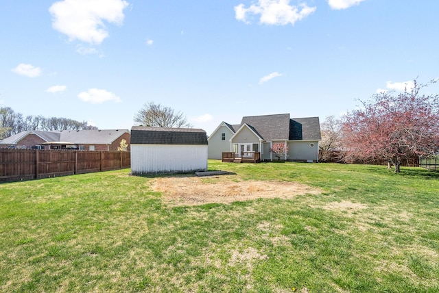 view of yard featuring a deck and a storage unit