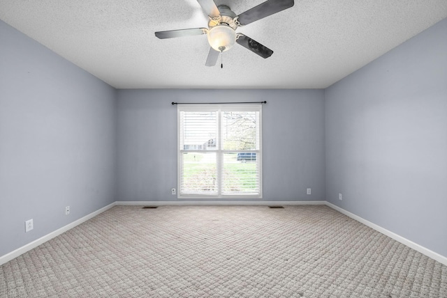 carpeted spare room with ceiling fan and a textured ceiling