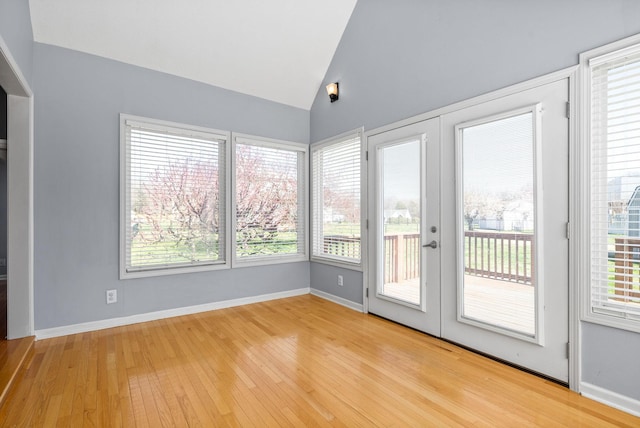 interior space with vaulted ceiling and light hardwood / wood-style floors