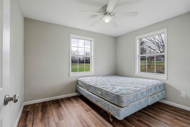 bedroom featuring ceiling fan and dark hardwood / wood-style flooring