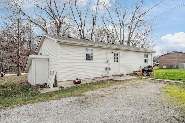 back of house with a lawn