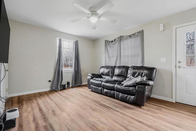 living room with ceiling fan and light hardwood / wood-style flooring