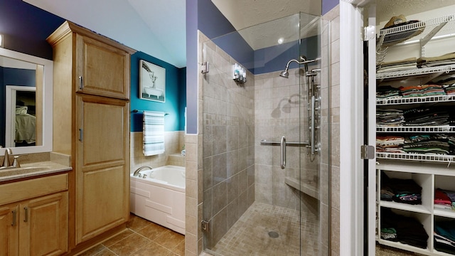 bathroom featuring vanity, tile patterned floors, and independent shower and bath