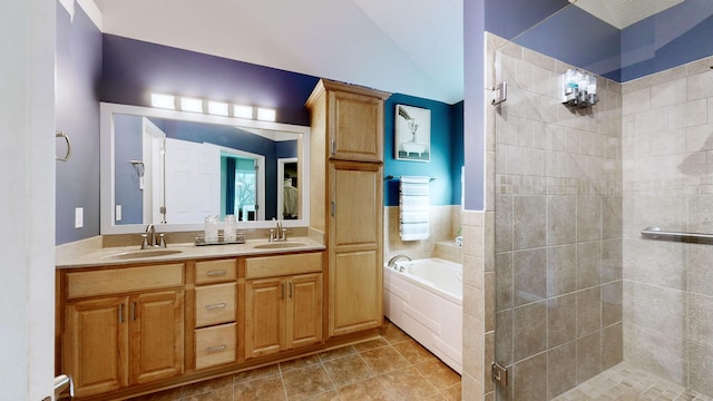 bathroom with tile patterned flooring, vanity, tile walls, and independent shower and bath