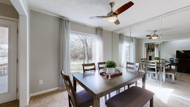 dining space with ceiling fan and a textured ceiling