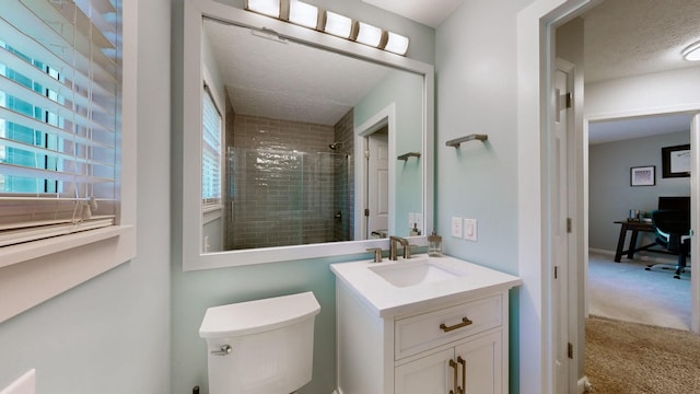 bathroom featuring vanity, a shower with shower door, a textured ceiling, and toilet