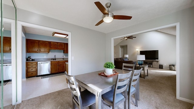 carpeted dining area featuring ceiling fan and sink