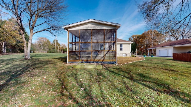 exterior space with a sunroom and a lawn