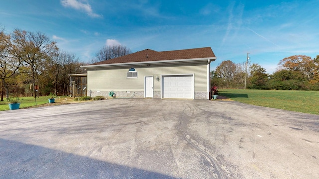 view of home's exterior with a yard and a garage