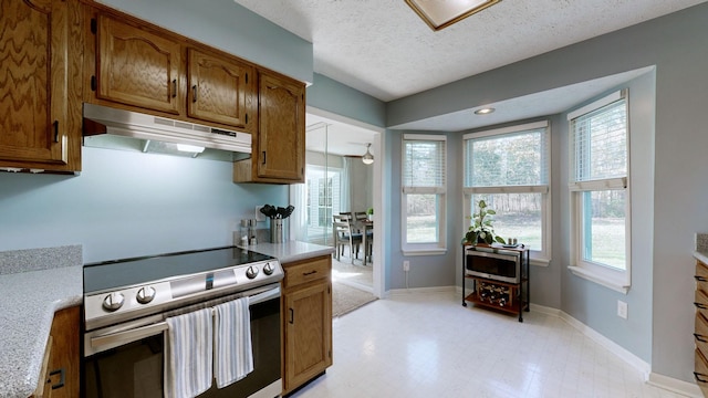 kitchen featuring a textured ceiling and stainless steel range with electric stovetop