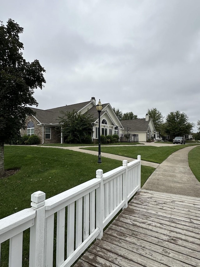 view of dock with a lawn