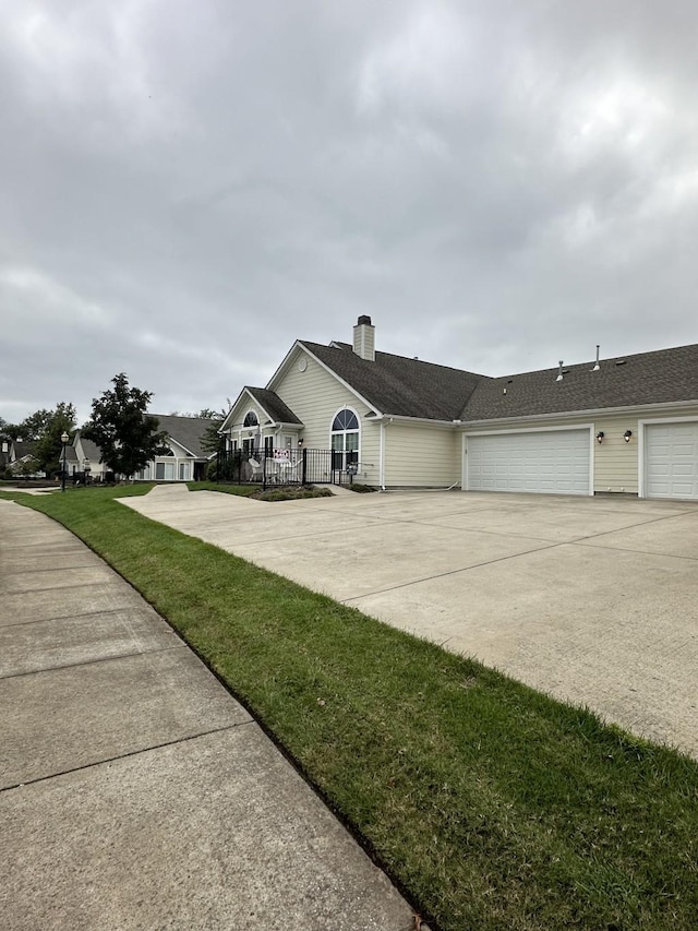 single story home with a garage and a front yard