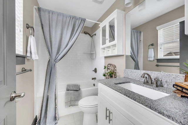 full bathroom featuring tile patterned floors, shower / tub combo with curtain, vanity, and toilet