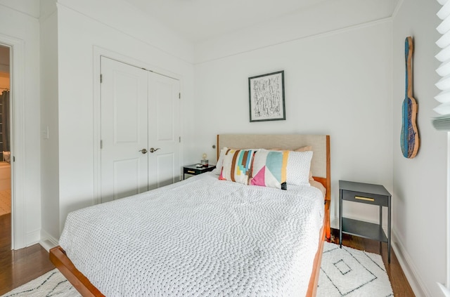 bedroom with hardwood / wood-style floors and a closet