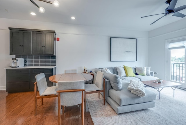 dining area with ceiling fan and light hardwood / wood-style floors